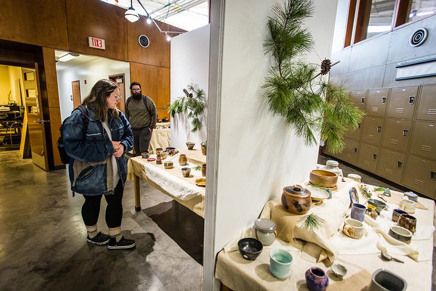 Patrons take in some of the ceramic work at a previous  art show and sale at Northwest. (Photo by Lauren Adams/Northwest Missouri State University)